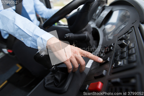 Image of close up of driver driving passenger bus