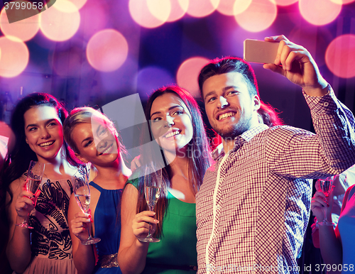 Image of friends with glasses and smartphone in club