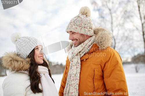 Image of happy couple walking over winter background