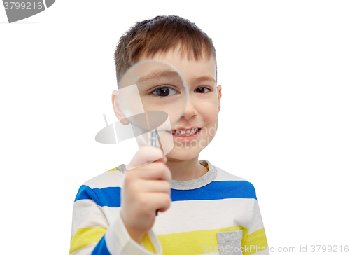 Image of happy little boy looking through magnifying glass