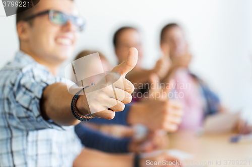 Image of group of happy students showing thumbs up