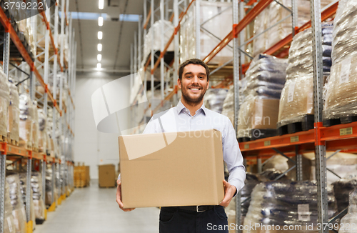 Image of happy man with cardboard parcel box at warehouse