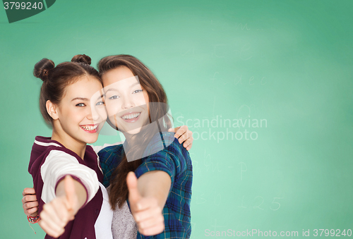 Image of happy teenage student girls showing thumbs up