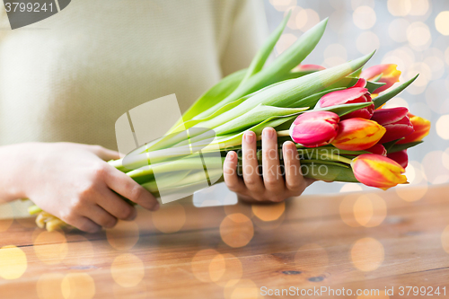 Image of close up of woman holding tulip flowers