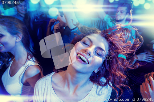 Image of smiling friends dancing in club