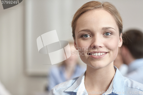 Image of group of smiling businesspeople meeting in office