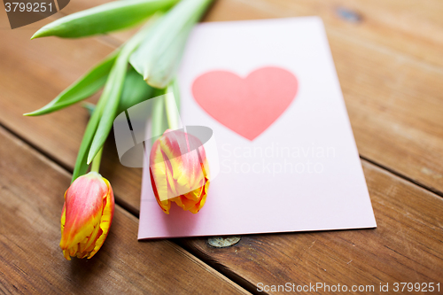 Image of close up of flowers and greeting card with heart