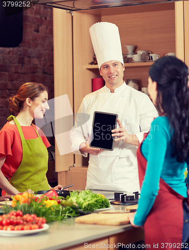 Image of happy women with chef and tablet pc in kitchen