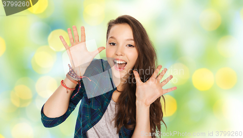 Image of happy laughing pretty teenage girl showing hands