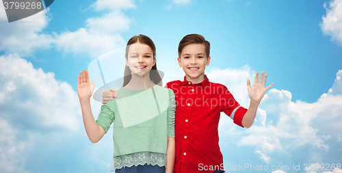 Image of happy boy and girl waving hand