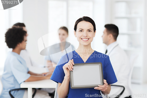 Image of happy doctor over group of medics at hospital