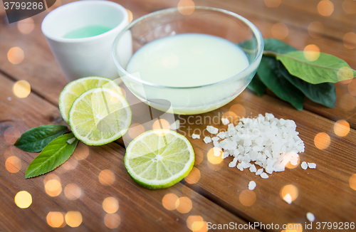 Image of close up of body lotion, cream and salt on wood