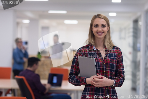 Image of portrait of young business woman at office with team in backgrou