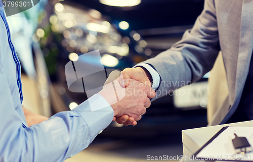 Image of close up of male handshake in auto show or salon