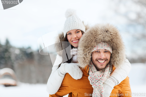 Image of happy couple having fun over winter background