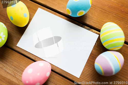 Image of close up of easter eggs and blank white paper