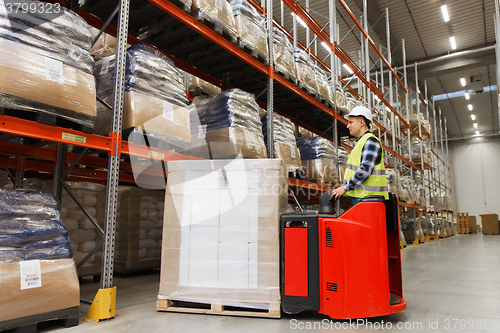 Image of man on forklift loading cargo at warehouse