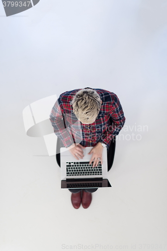 Image of top view of young business woman working on laptop computer