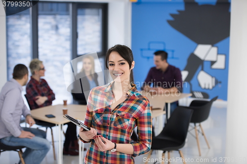 Image of portrait of young business woman at office with team in backgrou