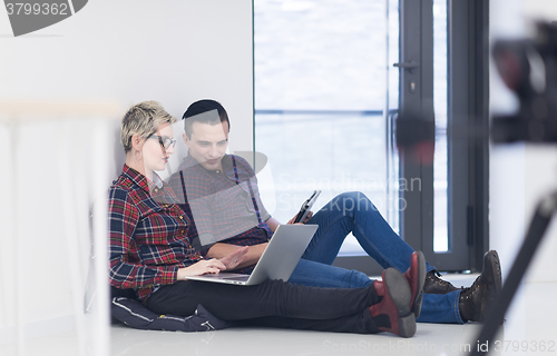 Image of startup business, couple working on laptop computer at office