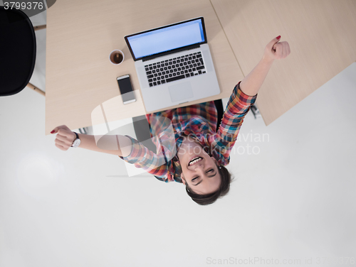 Image of top view of young business woman working on laptop