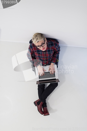 Image of top view of young business woman working on laptop computer