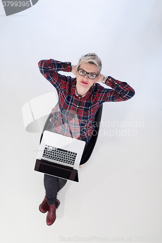 Image of top view of young business woman working on laptop computer
