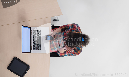 Image of top view of young business woman working on laptop