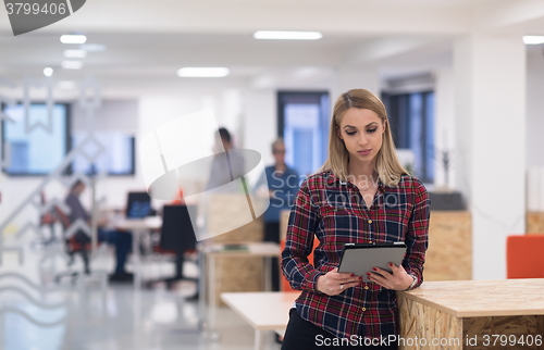 Image of portrait of young business woman at office with team in backgrou