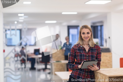 Image of portrait of young business woman at office with team in backgrou