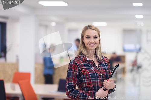 Image of portrait of young business woman at office with team in backgrou