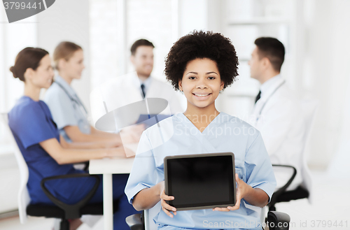 Image of happy doctor over group of medics at hospital