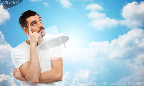 Image of man thinking over blue sky