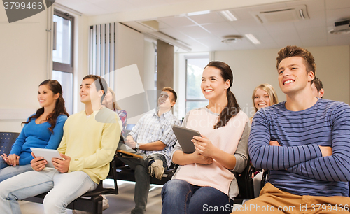 Image of group of smiling students with tablet pc