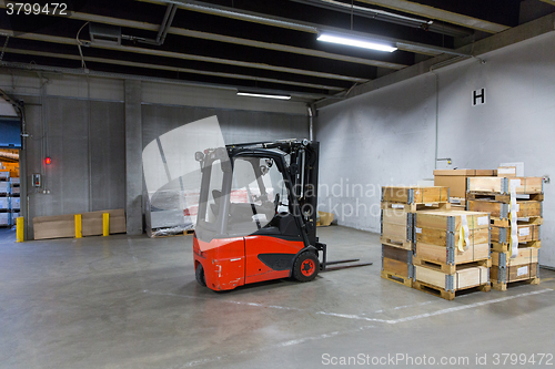 Image of forklift loader and boxes at warehouse