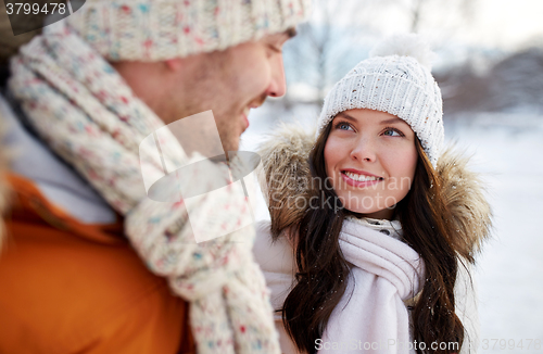 Image of happy couple walking over winter background