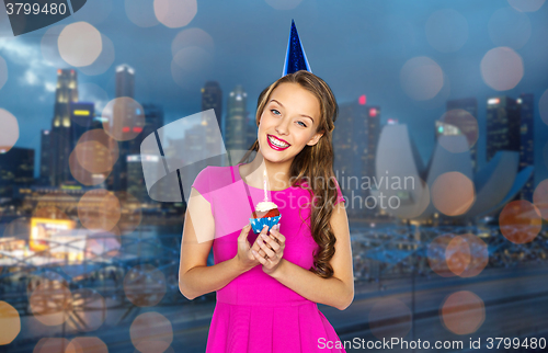 Image of happy woman or teen girl with birthday cupcake