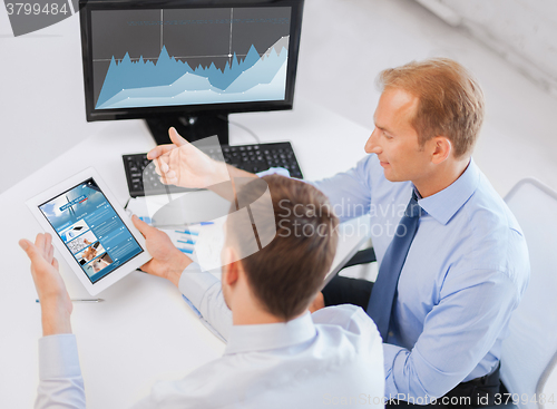 Image of businessmen with tablet pc and computer at office