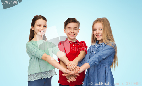 Image of happy boy and girls with hands on top