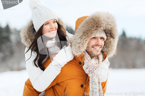 Image of happy couple having fun over winter background