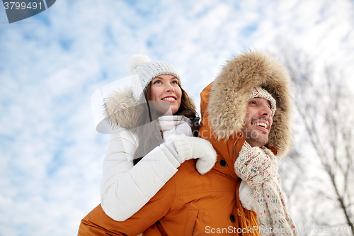 Image of happy couple having fun over winter background