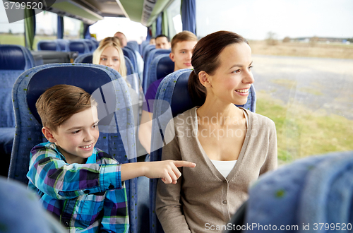 Image of happy family riding in travel bus