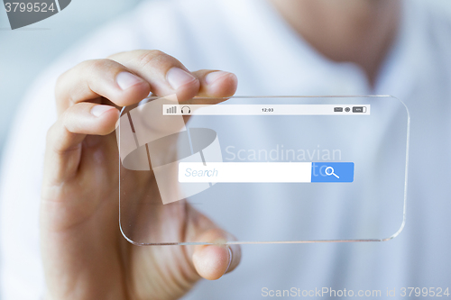 Image of close up of hand with search bar on smartphone