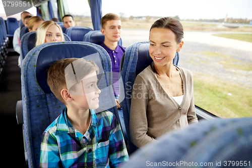 Image of happy family riding in travel bus