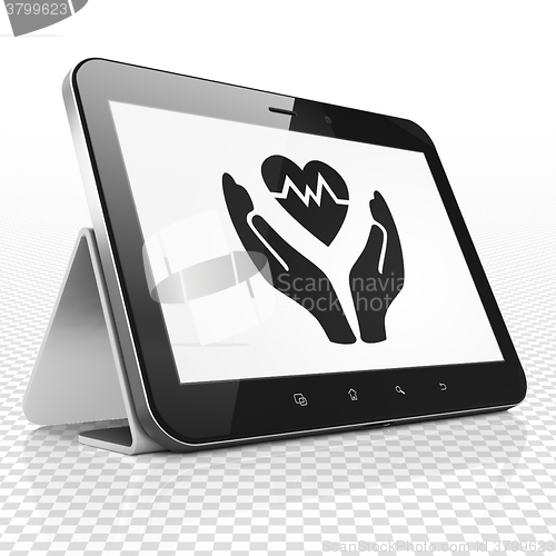 Image of Insurance concept: Tablet Computer with Heart And Palm on display