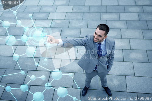 Image of young smiling businessman outdoors from top