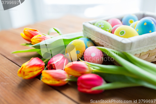 Image of close up of colored easter eggs and flowers