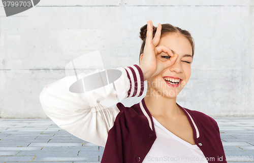 Image of happy teenage girl making face and having fun