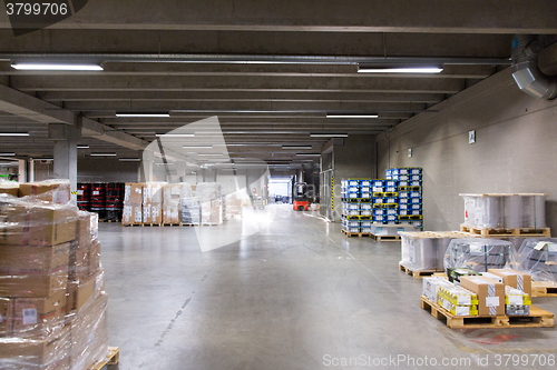 Image of forklift loader and boxes at warehouse