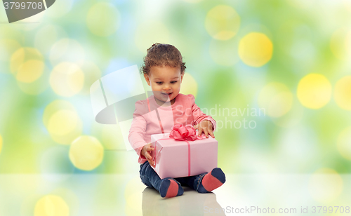 Image of happy little baby girl with birthday present